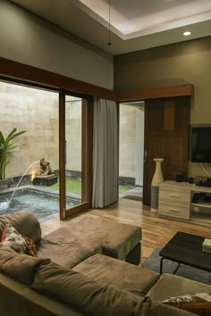 a living room filled with furniture and a fire place next to a sliding glass door