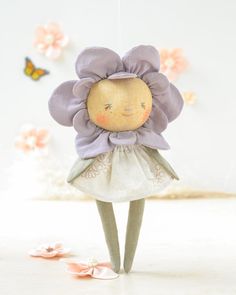 the doll is wearing a dress with flowers on it