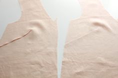 two pieces of pink fabric with holes cut out