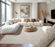 a modern living room with white furniture and large windows