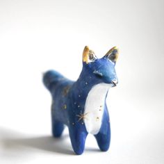 a small blue and white animal figurine on a white surface