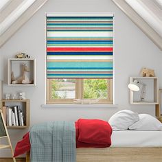 a bedroom with a bed and window covered in multicolored roman blind shades on the windows