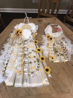 sunflowers and feathers are on display at the table