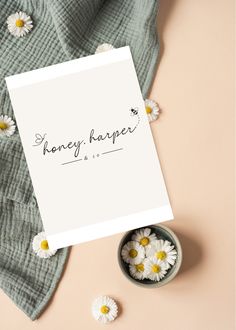 a paper with the words honey harper on it next to some daisies