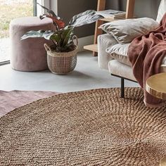 a living room with couches and rugs on the floor