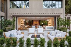 an outdoor living area with couches and chairs