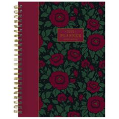 a planner with red flowers and green leaves on the cover, in front of a white background