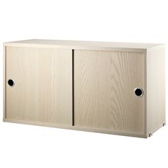 a wooden cabinet with two black holes in it