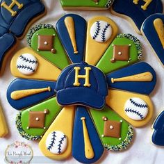 a decorated cookie with baseballs, mitts and hats on it's side