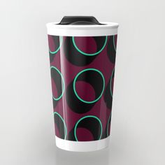 a purple and black coffee cup with circles on it