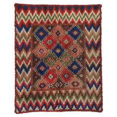 an old rug with multicolored designs on the front and back side, in various colors