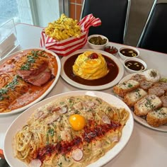 several plates of food on a white table