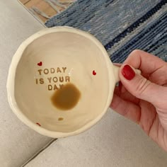 a person holding a coffee mug with the words today is your day written on it