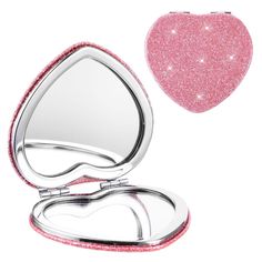 a compact mirror with pink glitter on the lid and in the shape of a heart