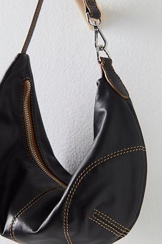 So chic in a crescent-shaped silhouette, this slouchy bag is featured in a soft leather fabrication and unstructured design with a top-zip closure and fixed shoulder strap. **Features:** Soft leather fabrication with silk-lined interior, slouchy crescent shape, contrast seaming, top-zip closure, fixed shoulder strap **Why We ❤ It:** The perfect goes-with-everything bag, this is one you’ll be reaching for again and again. | Real World Clutch Bag by FP Collection at Free People in Black Classic Black Hobo Bag At Cheap Price, Cheap Chic Hobo Bag With Single Shoulder Strap, Cheap Trendy Hobo Shoulder Bag, Cheap Trendy Faux Leather Hobo Bag, Luxury Hobo Bag With Round Leather Handles, Free People Leather, Luxury Hobo Bag With Zipper Closure For Fall, Cheap Versatile Hobo Shoulder Bag, Affordable Classic Soft Leather Hobo Bag