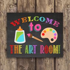 a welcome to the art room painted on a blackboard with paintbrushes and palettes