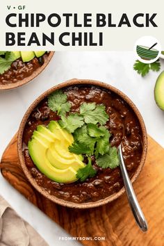 a bowl filled with beans and avocado on top of a wooden cutting board