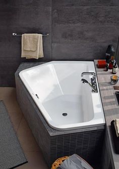 a large white bath tub sitting on top of a bathroom floor