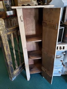 an old wooden cabinet is open on the floor