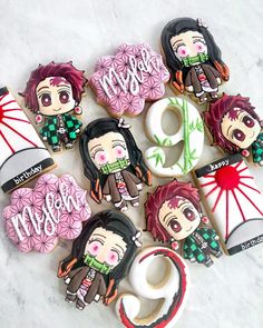 decorated cookies with anime characters on them sitting next to each other in the shape of donuts