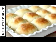 a pan filled with rolls sitting on top of a wooden table