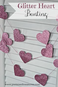 pink glitter heart bunting hanging from a white shuttered door with the words glitter heart bunting on it