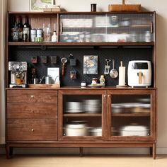 a wooden cabinet with many items on it