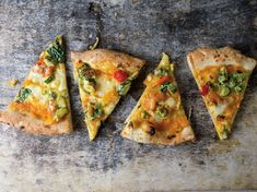 four slices of pizza sitting on top of a table