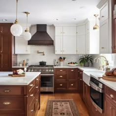 a kitchen with wooden cabinets and white counter tops, an area rug on the floor