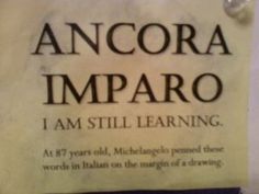 a sign that says ancora imparo i am still learning