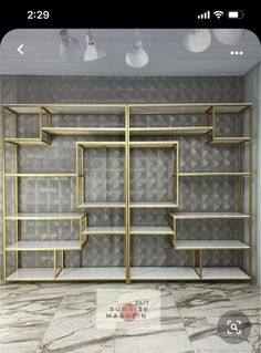 an empty room with gold shelves and lights