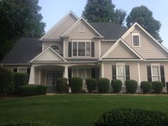 a gray house with white trim and black shutters