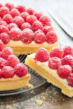 there is a cake with raspberries on it