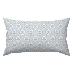 a blue and white pillow with an ornate design on it's back side,