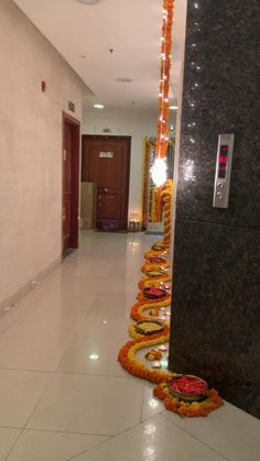 the hallway is decorated with orange and yellow garlands on each side, along with candles