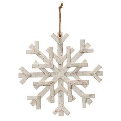 a wooden snowflake ornament hanging from a rope on a white background