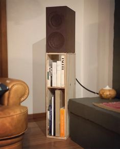 a bookshelf made out of wooden boxes with speakers on top