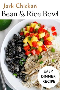 a bowl filled with beans, rice and other food on top of a white plate