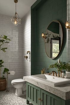 a bathroom with green and white walls, two sinks and a mirror on the wall