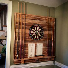 a dart board mounted on the wall with darts and other items in front of it