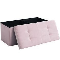 a pink and black ottoman sitting on top of a white floor