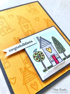 a congratulations card with a house and trees on it