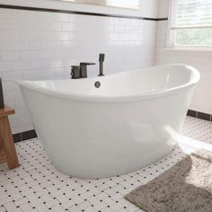 a white bath tub sitting on top of a bathroom floor