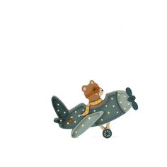 a teddy bear riding on top of an airplane