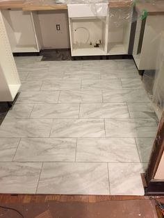 the kitchen floor is being installed in preparation for tile work on it's walls