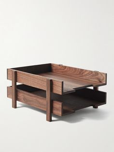 a wooden coffee table with two drawers on one side and an open drawer on the other