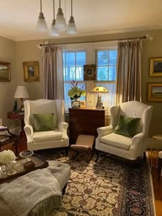 a living room with two chairs and a rug