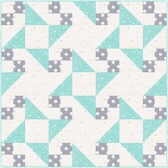 a blue and white quilt with small squares on the bottom, one in grey and one in light green