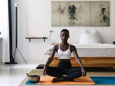 a woman is sitting in the middle of a yoga pose