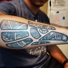 a man with a tattoo on his arm that has an image of a plane in it